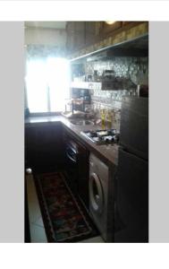 a kitchen with a stove and a sink at Appartement in Casablanca close to the beach in Casablanca