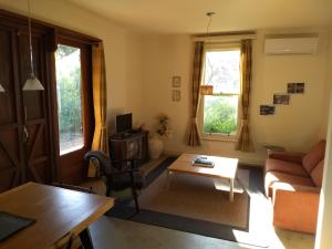 a living room with a couch and a table at Hotham Ridge Estate in Wandering