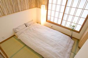 Voodi või voodid majutusasutuse Lucy's House横浜中華街 House3 toas