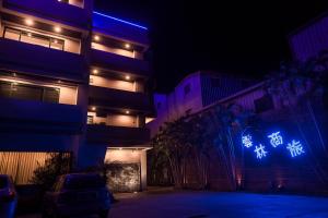 a building with lights on the side of it at night at Yunlin Commerce Ryokan in Tuku