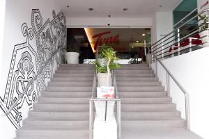 a stairway leading to a stairway with stairs at Tune Hotel - Waterfront Kuching in Kuching