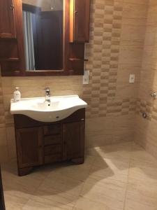 a bathroom with a sink and a mirror at Casa Mendeleev in Bucharest