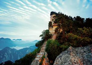 a building on the side of a mountain at Huashan International Youth Hostel in Huayin