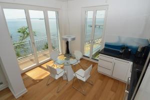 a kitchen with a table and chairs and a balcony at Ostseeresidenz Sassnitz F548 Penthouse 19 mit Sauna, Balkon, Meerblick in Sassnitz