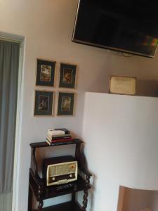 a room with a television and a radio on a table at B&B Casa Lulù in Brembate +21 photos