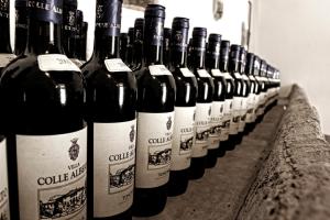 a row of wine bottles sitting on a table at Agriturismo Il Frantoio Di Colle Alberto in Montale