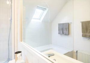 a white bathroom with a sink and a shower at Brussels Guest House in Brussels +44 photos