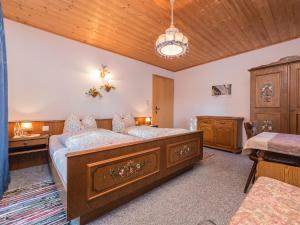 a bedroom with a large bed with a dresser and a desk at Xanderhof in Leutasch