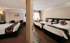 Ένα ή περισσότερα κρεβάτια σε δωμάτιο στο Hanoi Emotion Hotel