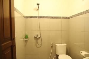 a bathroom with a shower with a toilet at Sedana Jaya in Ubud