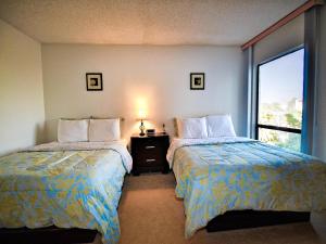 a hotel room with two beds and a window at 440 West Condos 408N in Clearwater Beach +17 photos