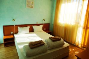 a bedroom with a bed with two towels on it at Guest House Misha in Petrevene +66 photos