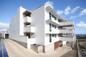a white building with the ocean in the background at Cardon Big Calm 12 in Costa Calma