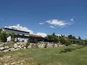 a house with a stone wall in front of a yard at Agriturismo 30 in Moniga