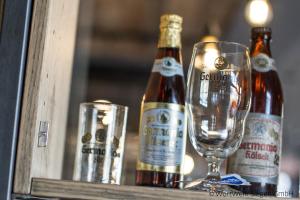 two bottles of wine and a glass on a table at GERMANIA Wissen in Wissen