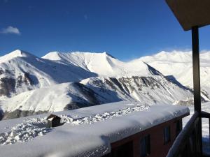 a view of a snow covered mountain from a building at Gudauri Vano Apartments in Gudauri
