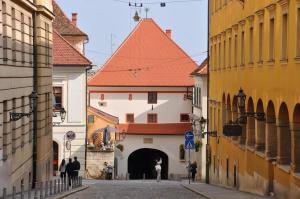 a building with a red roof in a street at Apartment San Marco in Zagreb