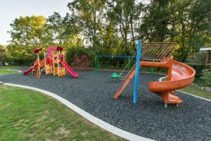 a playground with different colored play equipment in a park at Sun Retreats Lancaster County in Narvon