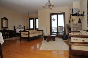 a living room with a couch and a table at Anthemion in Neochori