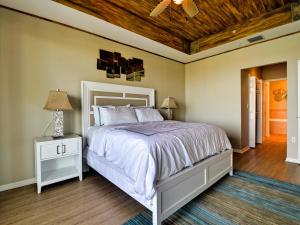 Un dormitorio con una cama blanca y un techo de madera. en Harborview Grande 802, en Clearwater Beach 18 fotos más