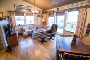 a living room with a couch and a table at Eiði Farmhouse in Grundarfjordur