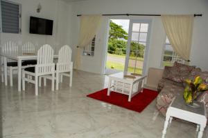 a living room with a couch and a table at Castles Apartments in Castries