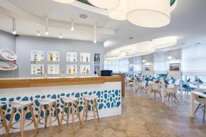 a dining room with blue and white stools at Hotel Aqua Sopot - Destigo Hotels in Sopot