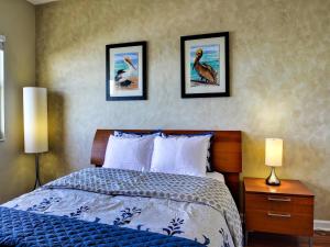 - une chambre avec un lit et trois photos sur le mur dans l'établissement Regatta Beach Club C713, à Clearwater Beach 17 autres photos
