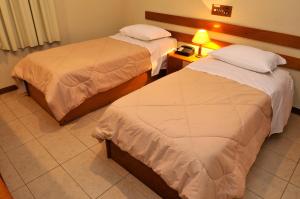 A bed or beds in a room at Assi Palace Hotel