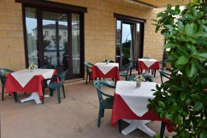 due tavoli con tovaglie rosse e bianche su un patio di Locanda Corte Girlanda a Verona