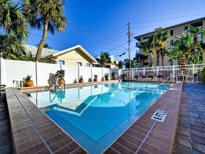 a swimming pool with blue water in a yard at Surfside Condos 204 in Clearwater Beach