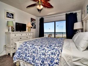 a bedroom with a bed and a television and a window at Surfside Condos 204 in Clearwater Beach +22 photos