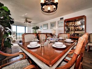 a dining room with a wooden table and chairs at Surfside Condos 204 in Clearwater Beach