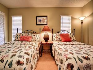 una camera con due letti e una lampada e finestre di Villas of Clearwater Beach 8A a Clearwater Beach Altre 23 foto