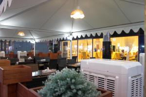 a dining room with tables and chairs and a restaurant at Royal Falcon Hotel in Dubai