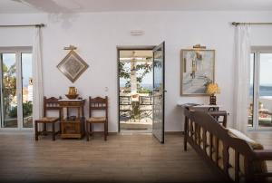 a room with white walls and a door with a mirror at Villa Pelagos in Platis Yialos Sifnos