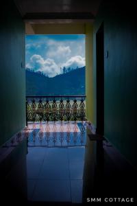 a view of a balcony with a view of the mountains at Smm Cottage in Munnar