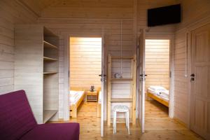a room with two beds and a table and a chair at U Sasiadow in Mielenko +15 photos