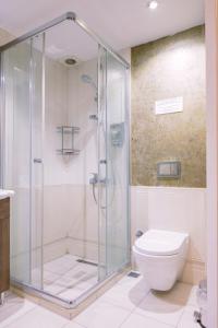 a bathroom with a shower and a toilet at Moda Hostel in Istanbul