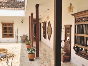 a hallway of a house with potted plants at Casa Passiflora Hotel Boutique in Jardin