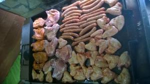 a bunch of different types of meat on a grill at Bungalows Ivona in Bastasi