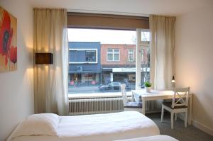 Ένα ή περισσότερα κρεβάτια σε δωμάτιο στο Central-Day Inn