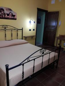 a bedroom with a bed with a white bedspread at Le Tre Caravelle in Trabia