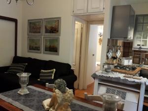 a living room with a black couch and a kitchen at Appartamento Golden Park in Castel di Sangro