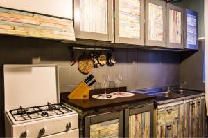 a kitchen with a stove and a sink with wine glasses at Casolare Rehva in Cecina