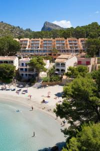 a view of a beach with people in the water at Universal Aparthotel Don Camilo in Sant Elm
