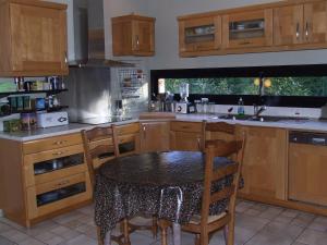 a kitchen with a table and chairs in it at Logis de Ponthus in Paimpont