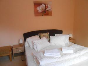 a bedroom with a bed with white sheets and pillows at Fatrapark 2 in Ružomberok