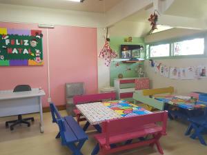 a room with a table and chairs and a table and a desk at Residencial Pousada do Serrano in Gramado