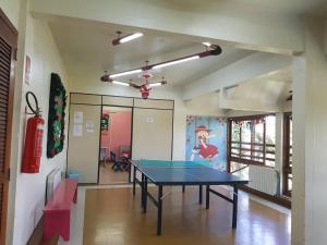 a ping pong table in the middle of a room at Residencial Pousada do Serrano in Gramado